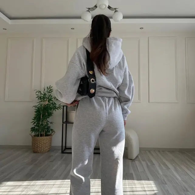 Person wearing casual comfy sweaters two piece and winter solid color sweatsuit with crossbody bag