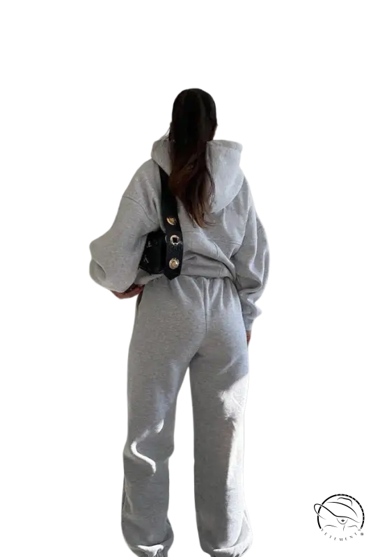 Person in casual comfy sweaters two-piece winter solid color set with dark crossbody bag