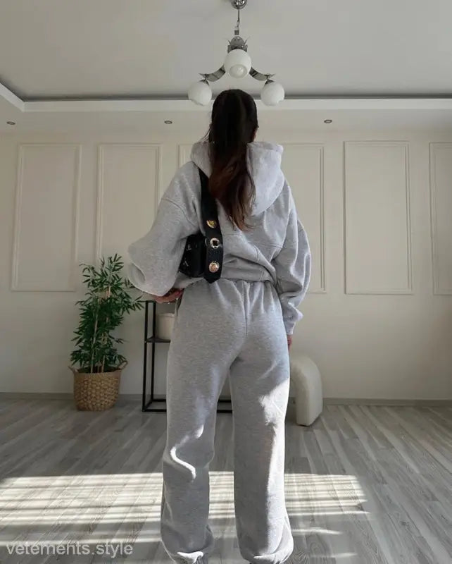 Person wearing casual comfy sweaters two piece and winter solid color sweatsuit with crossbody bag