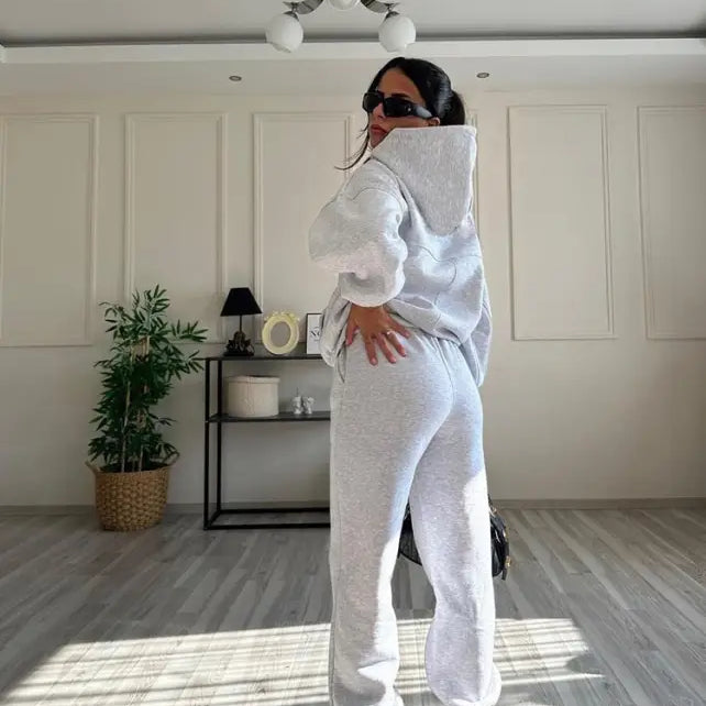 Woman in casual comfy sweaters two piece winter solid color hoodie set with sunglasses