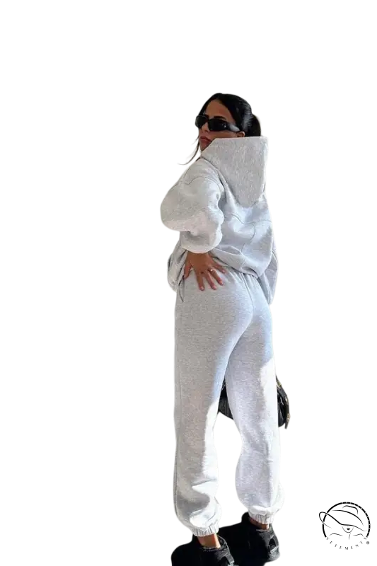 Woman in white casual comfy sweaters two-piece winter solid color set posing with hand on hip