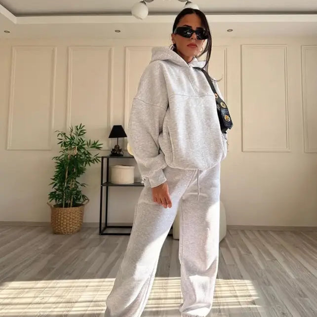 Woman wearing casual comfy sweaters two piece winter solid color set with sunglasses