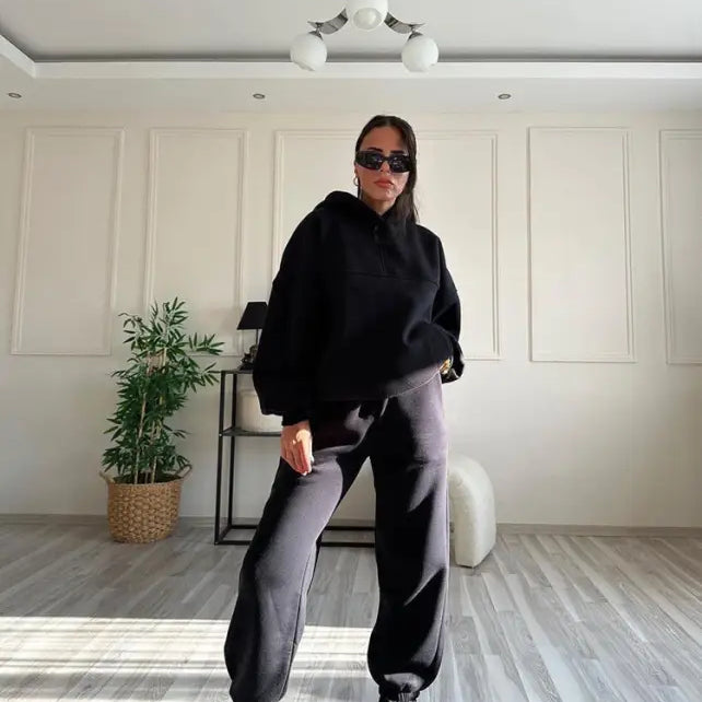 Woman in casual comfy sweaters two piece winter solid color set in minimalist interior