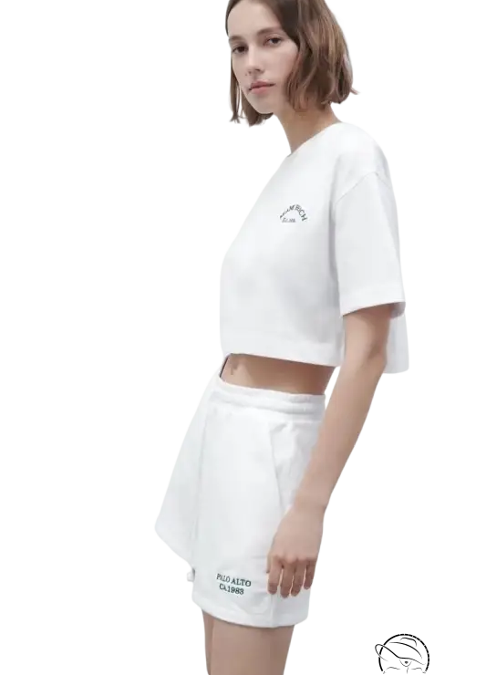 Woman in white crop top and Palo Alto set shorts
