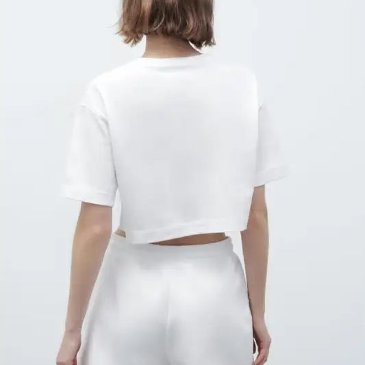 White crop top and shorts set from Palo Alto set styling featuring text flock shorts