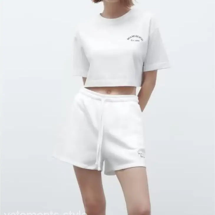 White crop top and shorts set from the Palo Alto set styling with text flock shorts