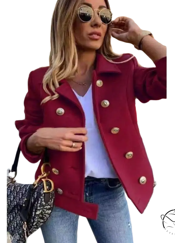 Burgundy double breasted jacket with gold buttons over white top and jeans