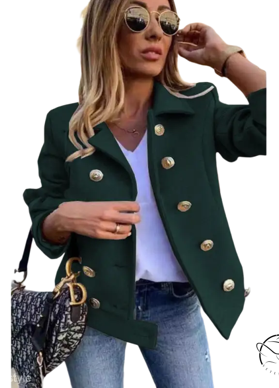 Green double breasted jacket with gold buttons over white top and jeans