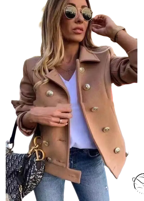 Stylish beige double breasted jacket with gold buttons and loose fit over white top and jeans