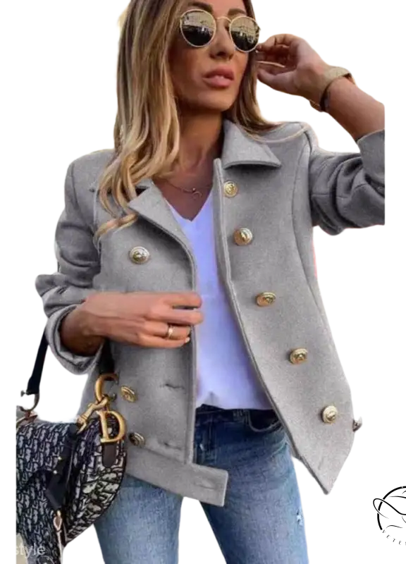 Stylish double breasted jacket in gray with gold buttons over white top and jeans