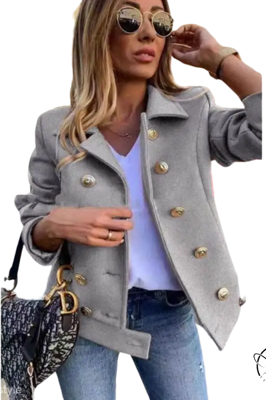 Stylish double breasted jacket in gray with gold buttons over white top and jeans