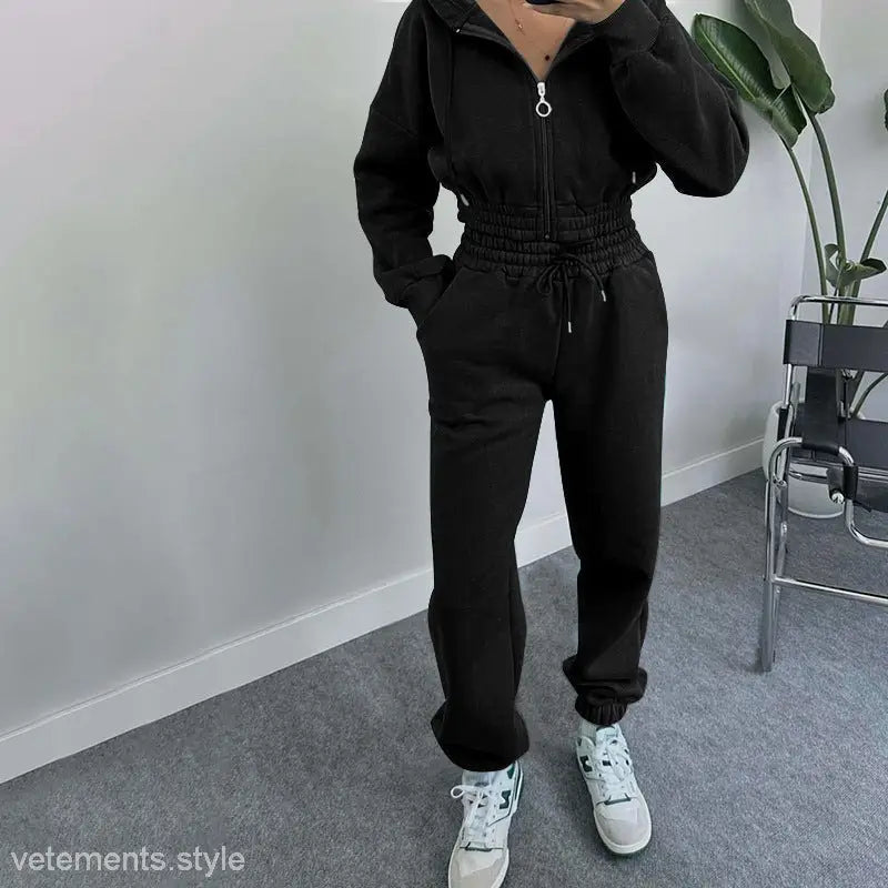 Black casual exercise suit with hooded zipper waist and white sneakers for spring and fall