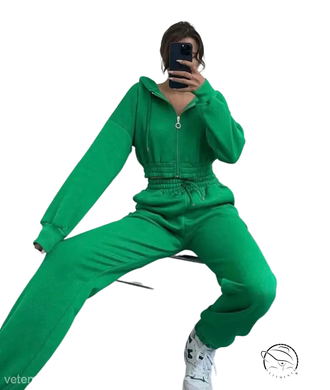 Person in bright green casual exercise suit with hooded zipper taking mirror selfie