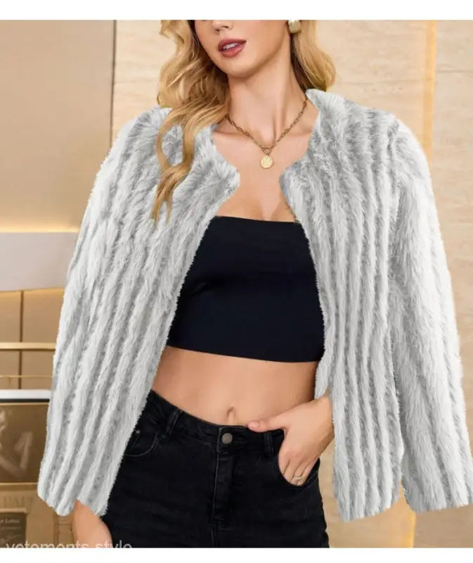 Faux fur overcoat styled with black crop top and jeans, ideal for fall and winter wear