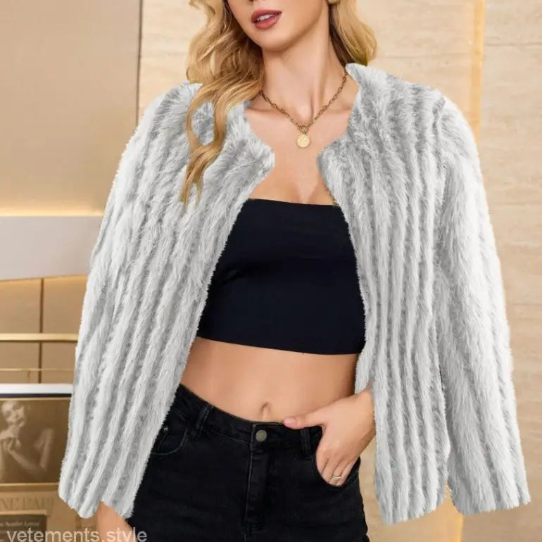 Faux fur overcoat layered over a black crop top and jeans, ideal for fall and winter fashion