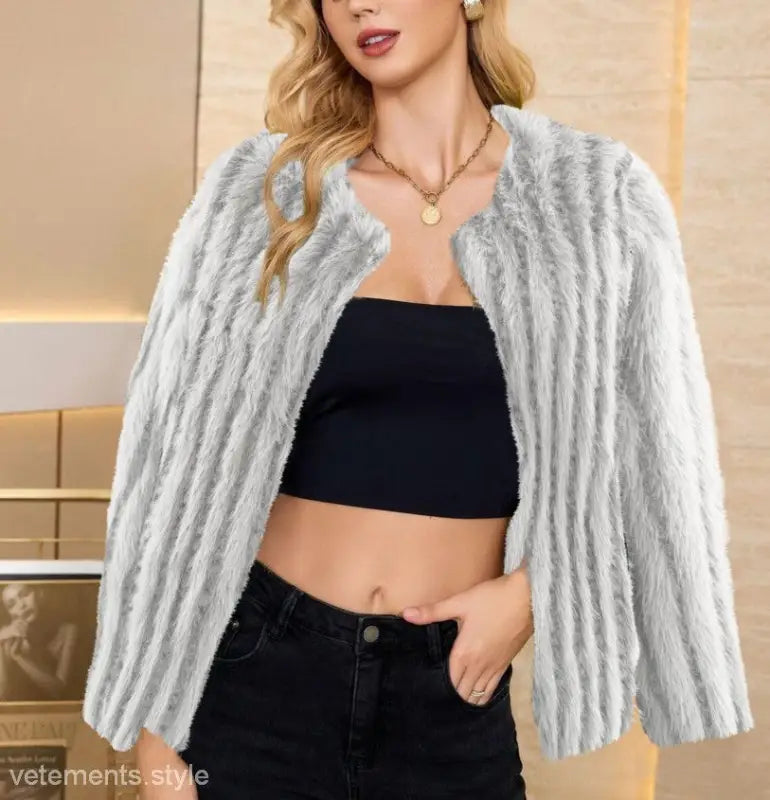 Faux fur overcoat layered over a black crop top and jeans, ideal for fall and winter fashion