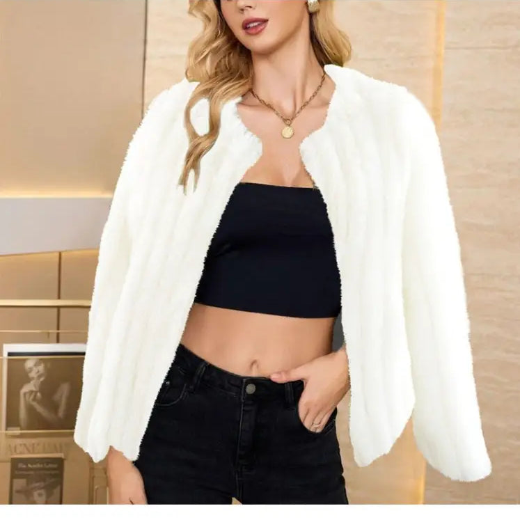White fluffy faux fur overcoat worn over black crop top, ideal for fall and winter fashion