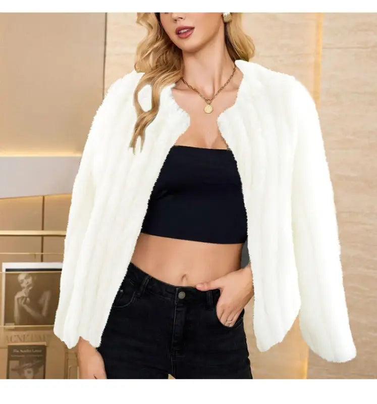 White fluffy faux fur overcoat worn over black crop top, ideal for fall and winter fashion