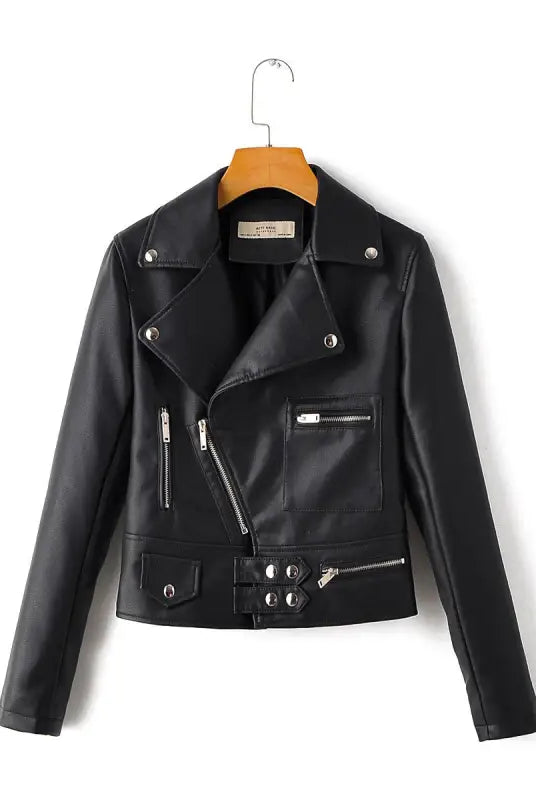 Faux leather biker jacket with silver zippers and studs on wooden hanger for fall winter