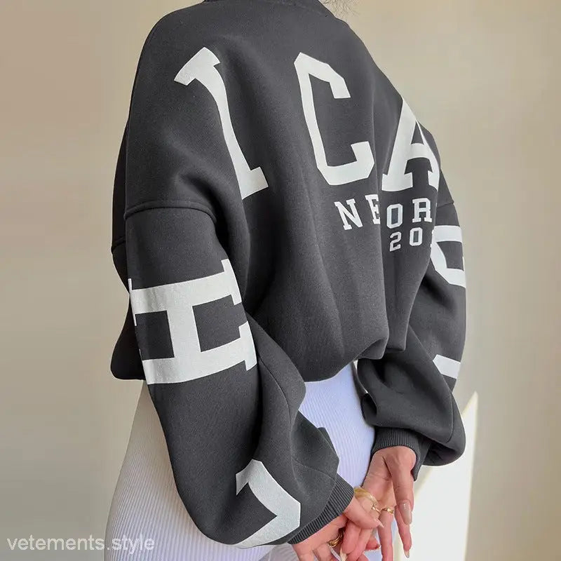 Gray knitted graphic printed hoodie featuring white lettering for stylish spring and fall wear
