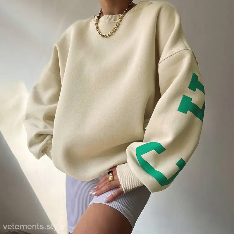 Oversized beige sweatshirt with green graphics, ideal knitted graphic printed hoodie for spring