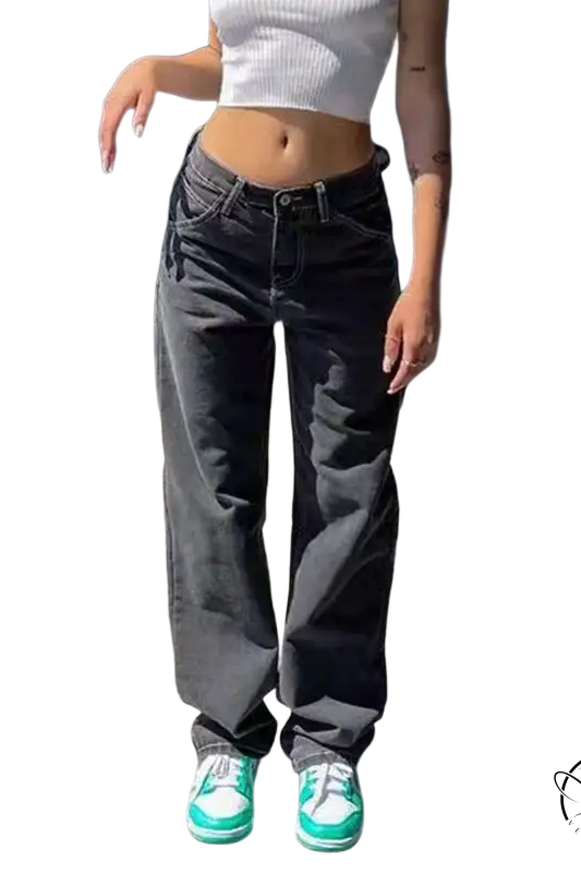 Person in white crop top, wide leg light blue jeans, and green sneakers