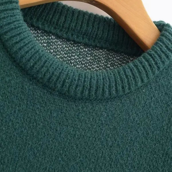 Green knit sweater on wooden hanger, perfect deer holiday sweater for Christmas festivities