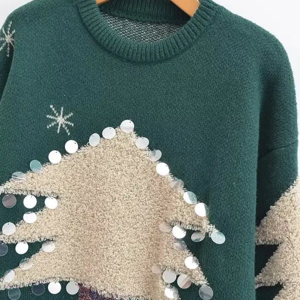 Green deer holiday sweater with beige tree-shaped decor and sequin embellishments