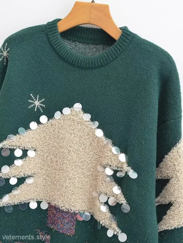 Green deer holiday sweater with beige tree-shaped decor and sequin embellishments