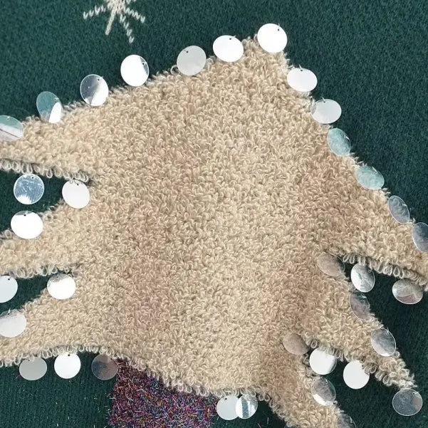 Beige fuzzy fabric Christmas deer holiday sweater with white ornaments and festive design