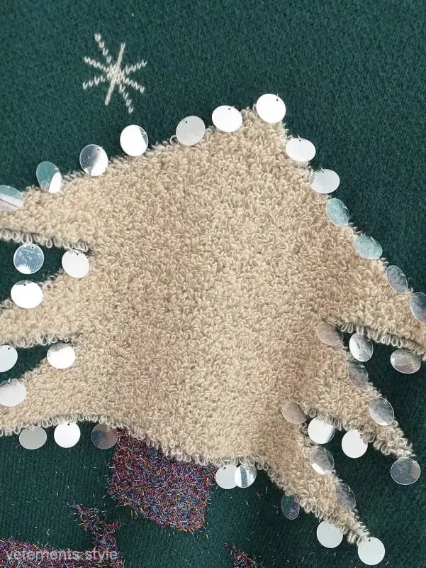 Beige fuzzy fabric Christmas deer holiday sweater with white ornaments and festive design