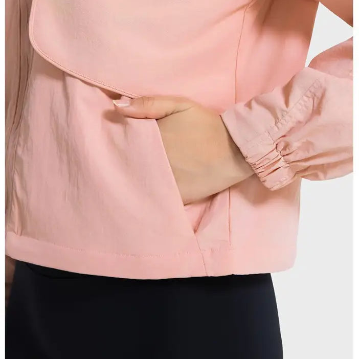 Peach-colored jacket with hand in pocket, ideal for pearlescent white albumin outfits