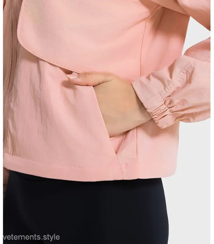 Peach-colored jacket with hand in pocket, ideal for pearlescent white albumin outfits