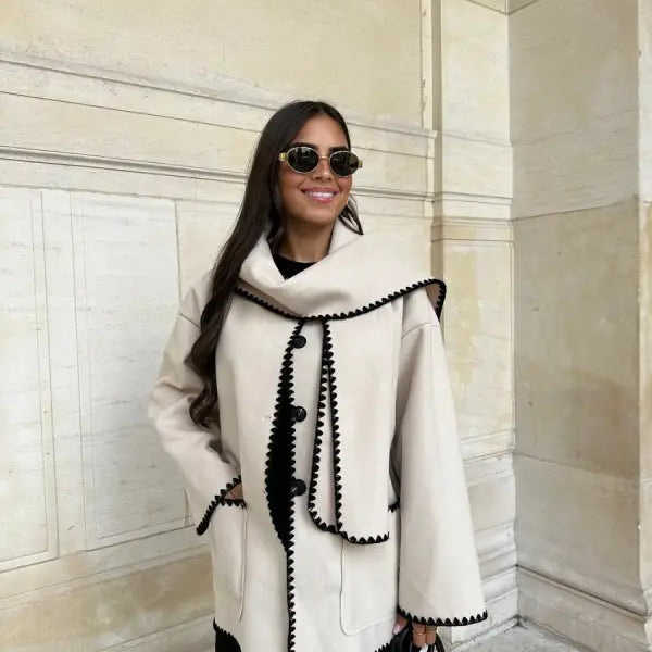 White coat with black trim and decorative stitching, ideal for contrast scarf woolen coat outfits