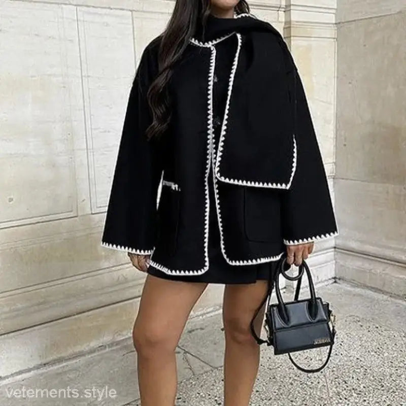 Black coat with white contrast stitching and layered design, ideal for scarf woolen coats
