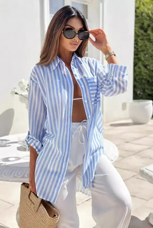 Casual mid length shirt dress featuring blue and pink stripes with pockets