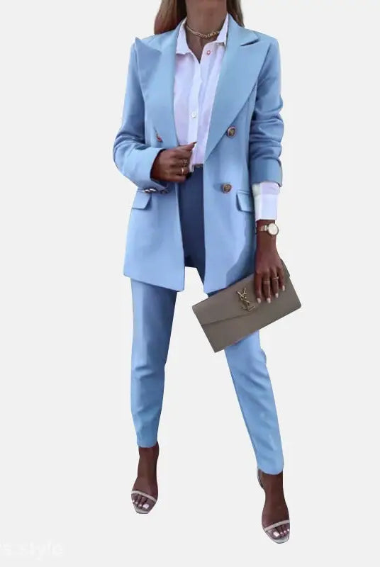 Light blue women’s suit with clutch for a spring casual office fit