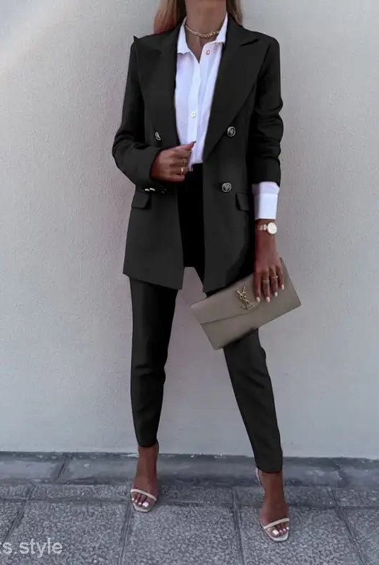 Casual office fit featuring a woman’s black pantsuit, white shirt, and clutch for spring autumn