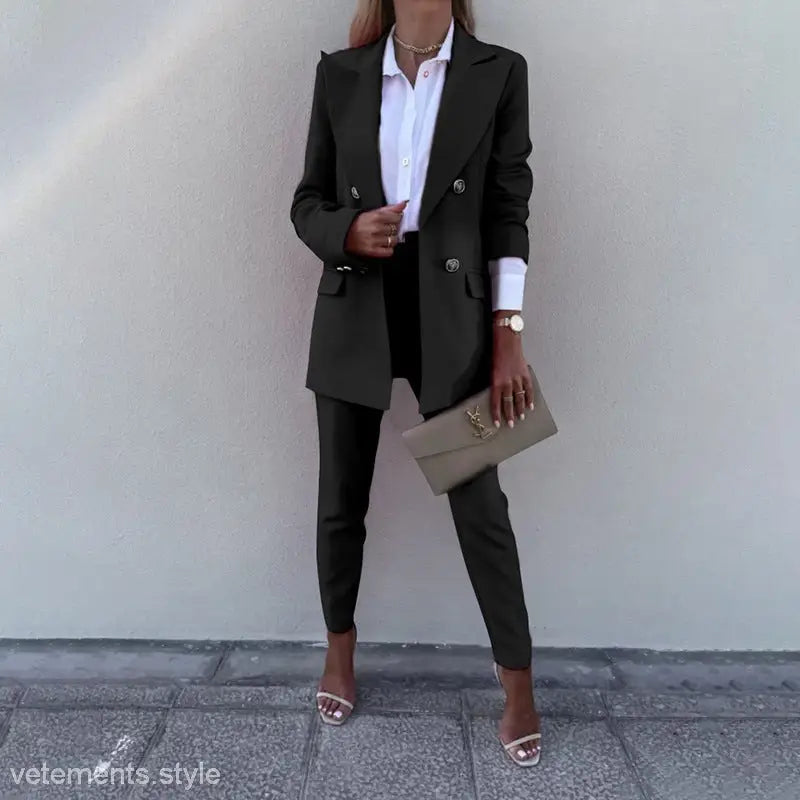Casual office fit featuring a woman’s black pantsuit, white shirt, and clutch for spring autumn