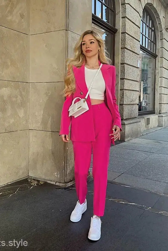 Woman in a pink pantsuit showcasing a casual office fit for spring and autumn
