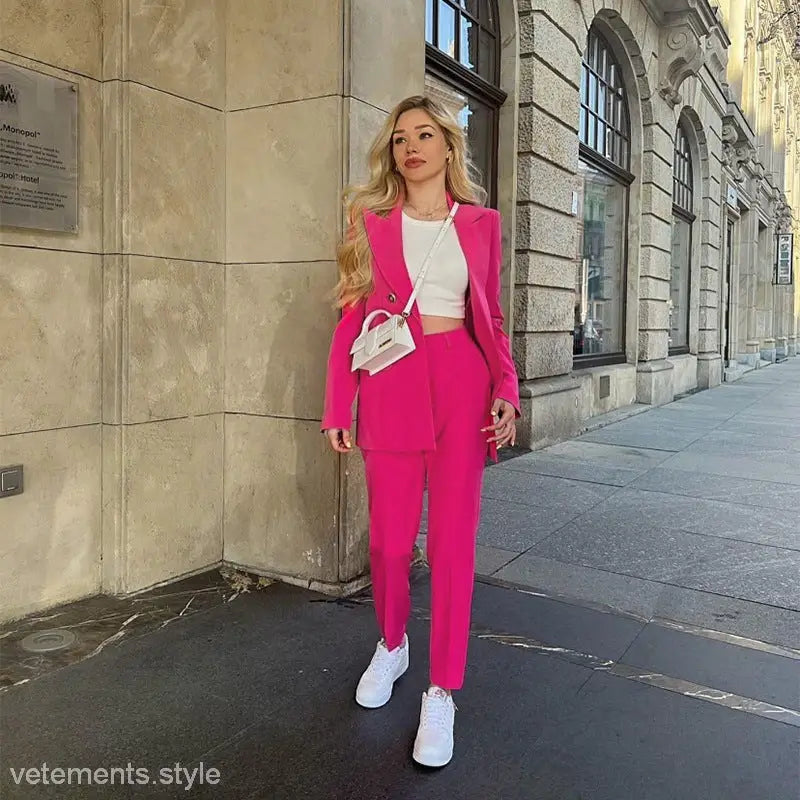 Woman in a pink pantsuit showcasing a casual office fit for spring and autumn