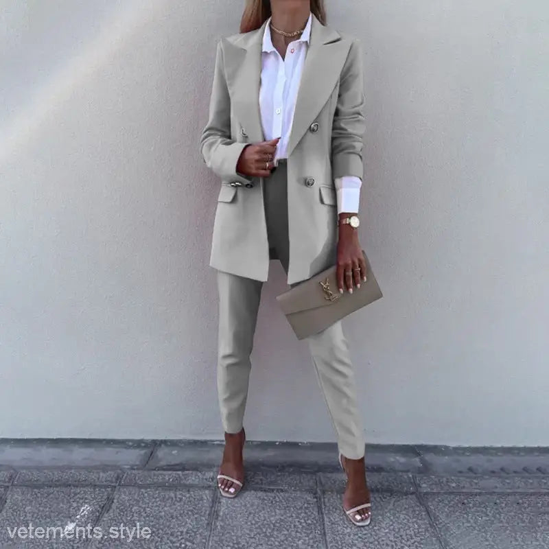 Woman in gray pantsuit showcasing casual office fit for spring and autumn solid color styles