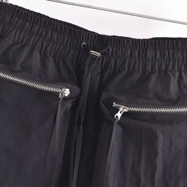 Black nylon pants with zippered pockets displayed with Casual Short Bomber Jacket