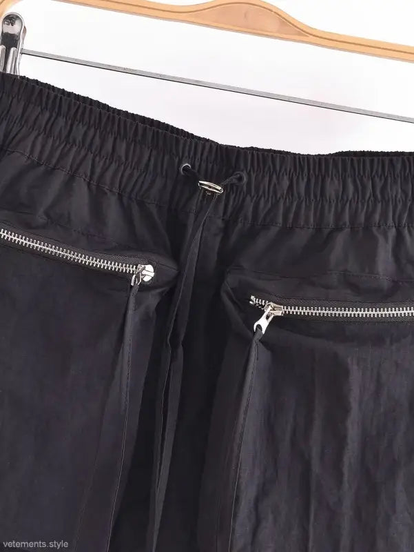 Black nylon pants with zippered pockets displayed with Casual Short Bomber Jacket