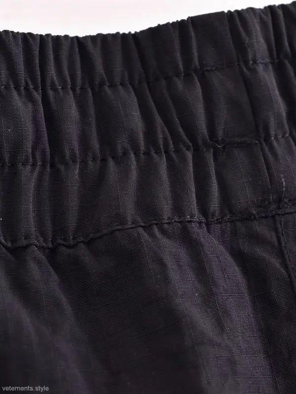 Black elastic waistband with visible stitching on Casual Short Bomber Jacket