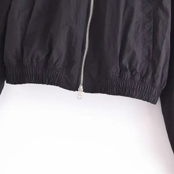 Black cropped short bomber jacket with silver zipper and elastic waistband, perfect for casual wear