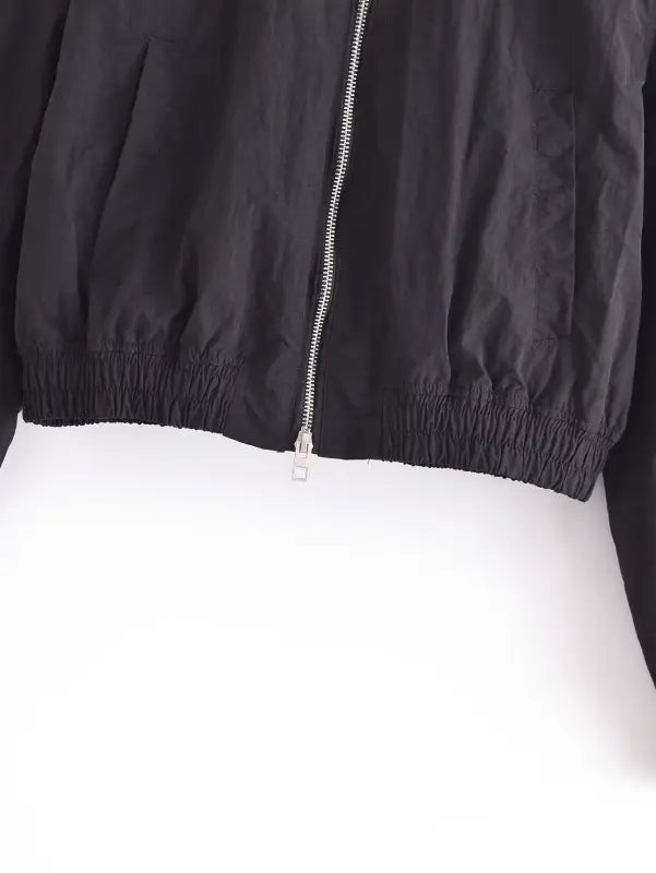 Black cropped short bomber jacket with silver zipper and elastic waistband, perfect for casual wear