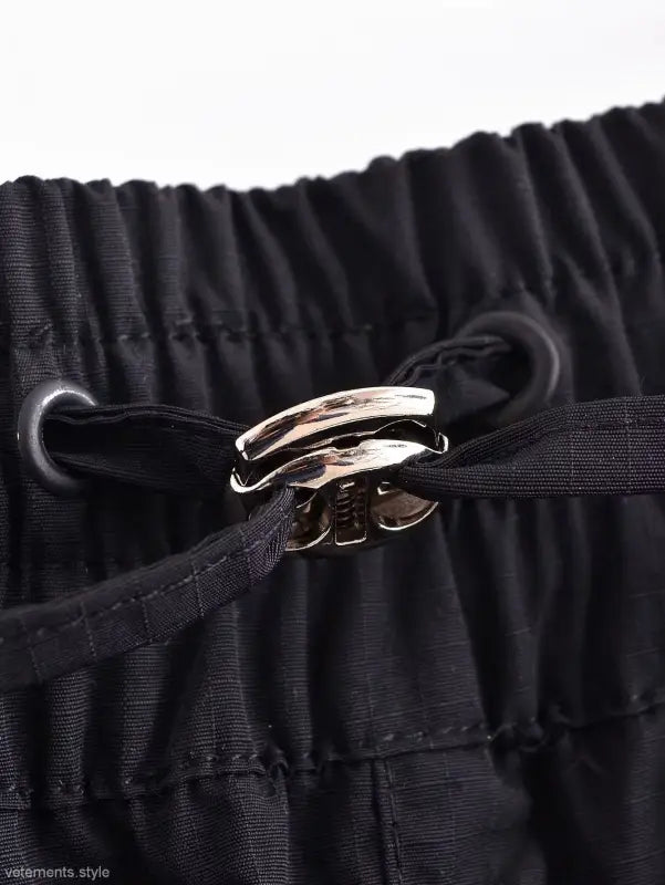 Metallic clasp on gathered black fabric of Casual Short Bomber Jacket with Pocket