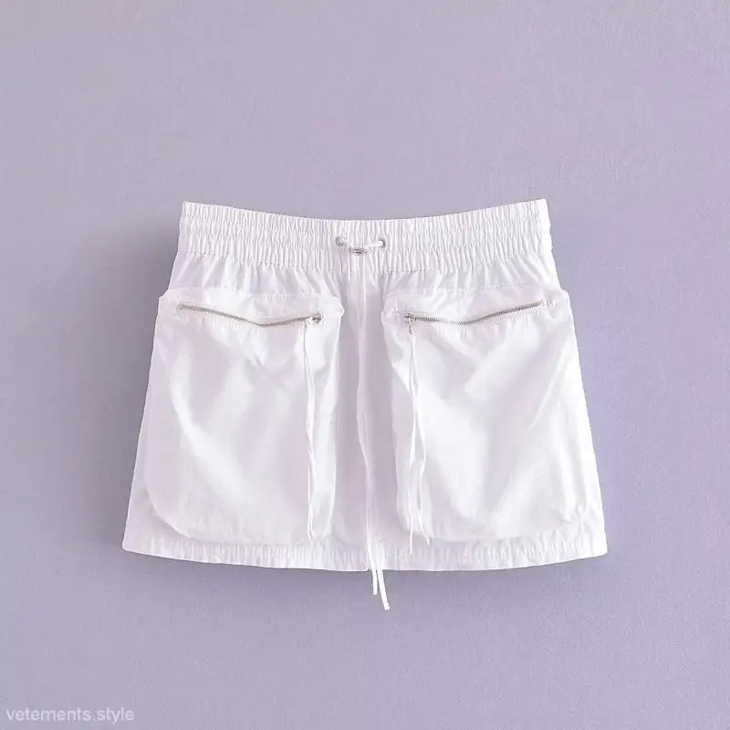 White drawstring mini skirt with zipper pockets paired with short bomber jacket