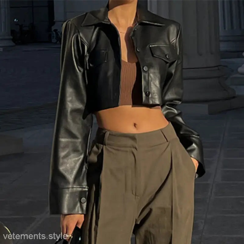 Cropped motorcycle jacket in black leather over brown top with olive trousers for a stylish look
